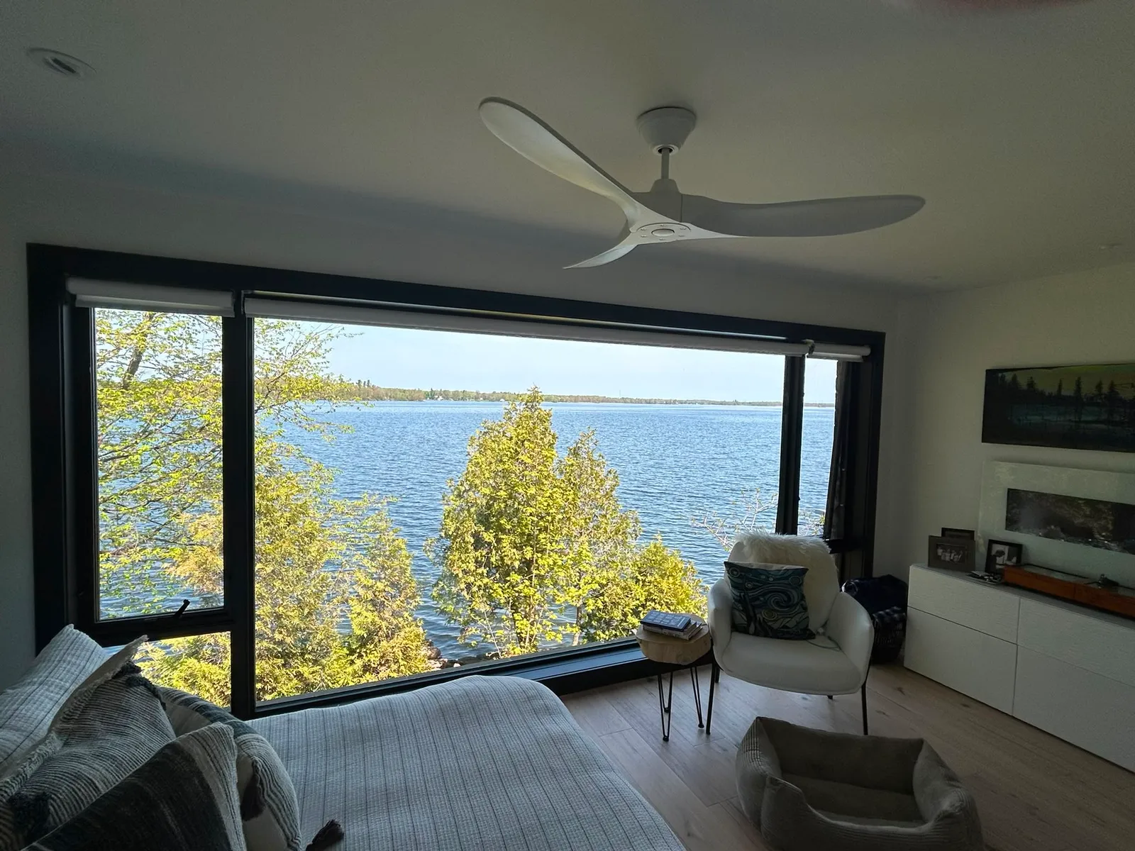 Freshly painted lakeside bedroom with a large picture window