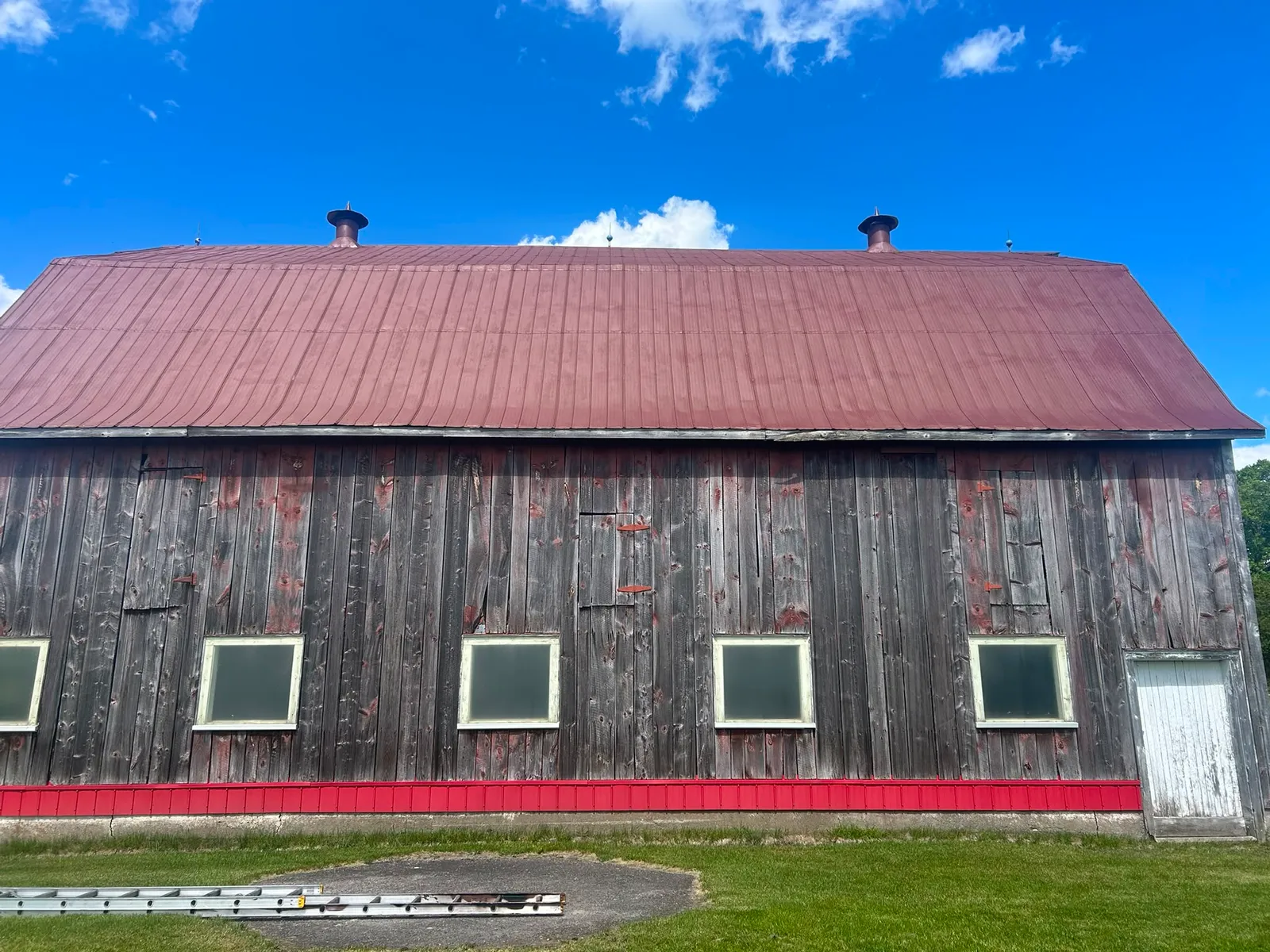 Barn with a freshly painted red metal roof