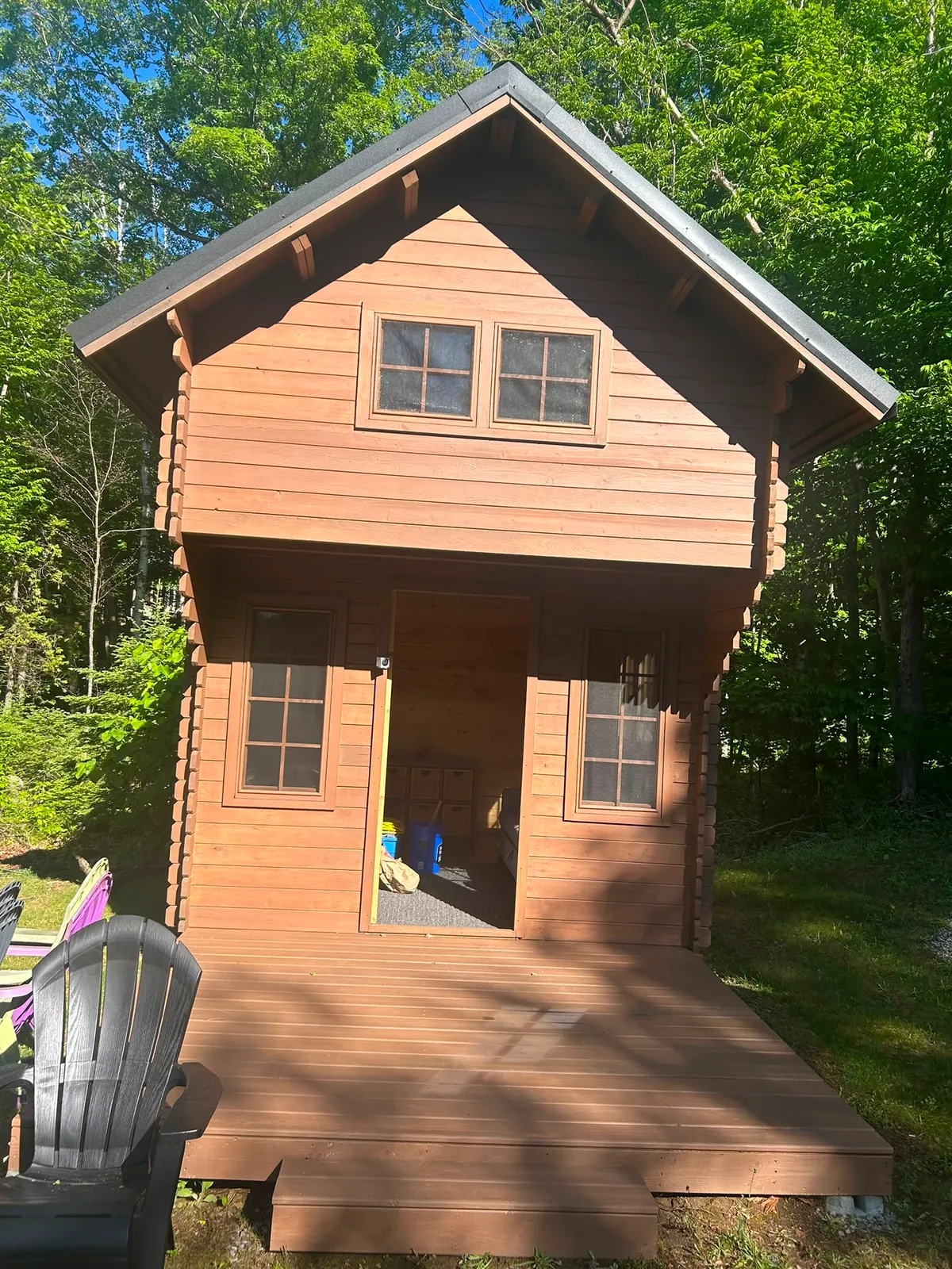 Freshly stained cabin and deck in the woods