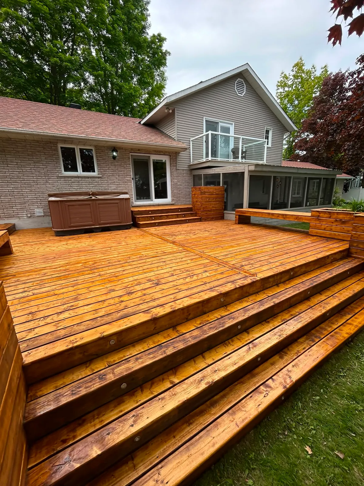Richly re-stained multi-level backyard deck in a Lanark County home