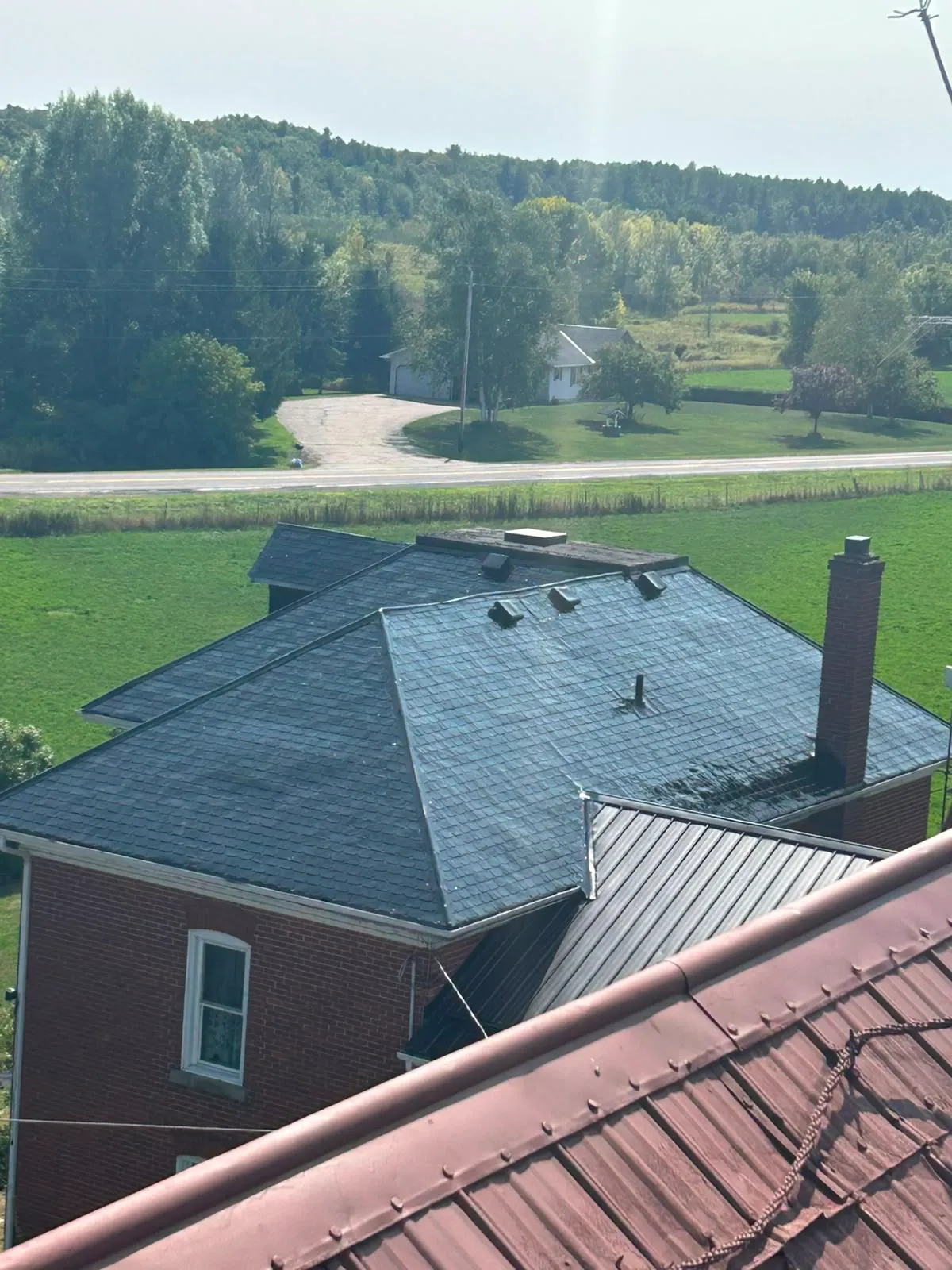 Elevated view over a large roof being coated
